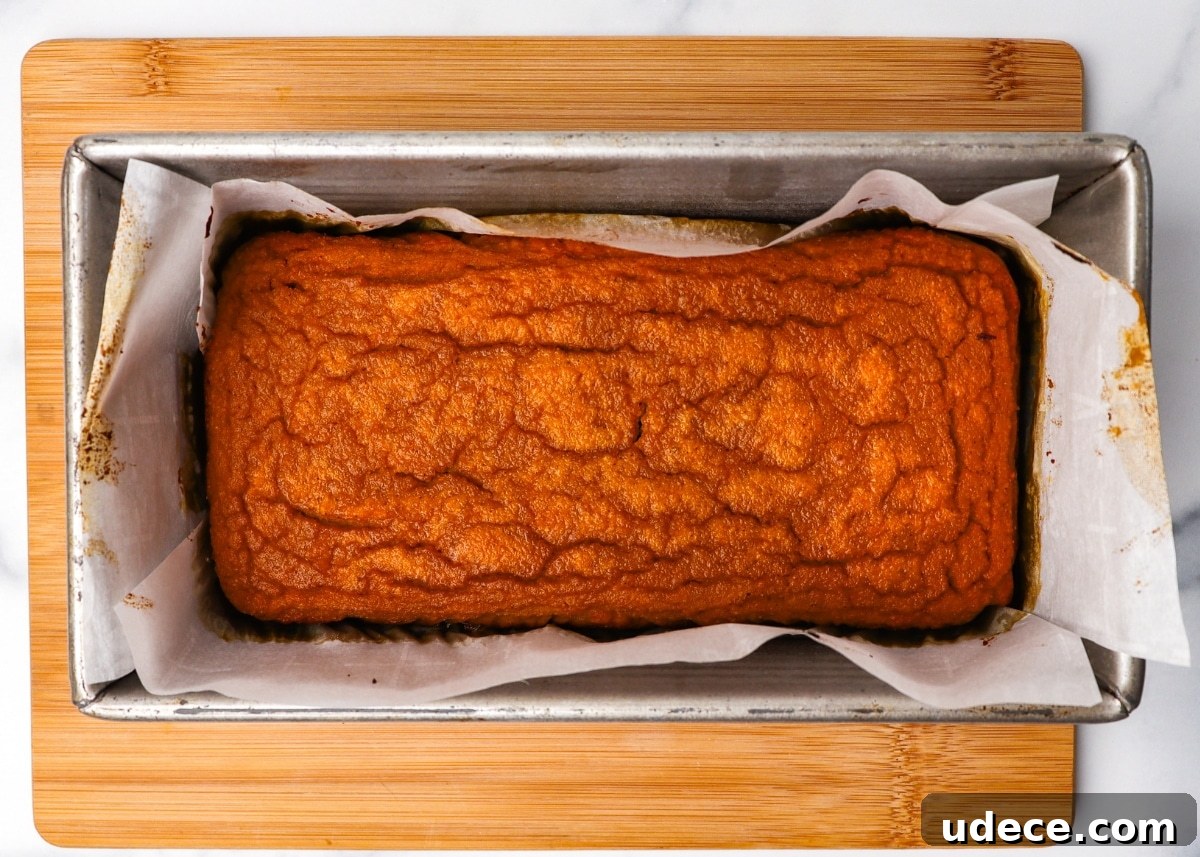 Moist Keto Pumpkin Bread Made with Coconut Flour 9 Overhead in bread pan and parchment paper fresh from oven