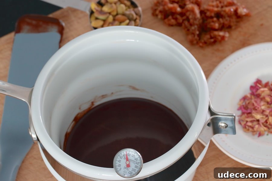 How to Make Rich Homemade Dark Chocolate from Scratch 5 Melted cocoa butter mixed with cacao powder; in the background minced dates, pistachios, and rose petals