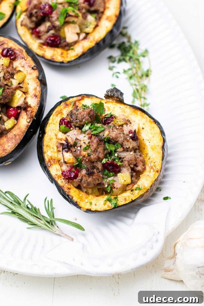 Sausage-Stuffed Acorn Squash Roast with Maple Glaze 2 A white platter with sausage stuffed acorn squash.