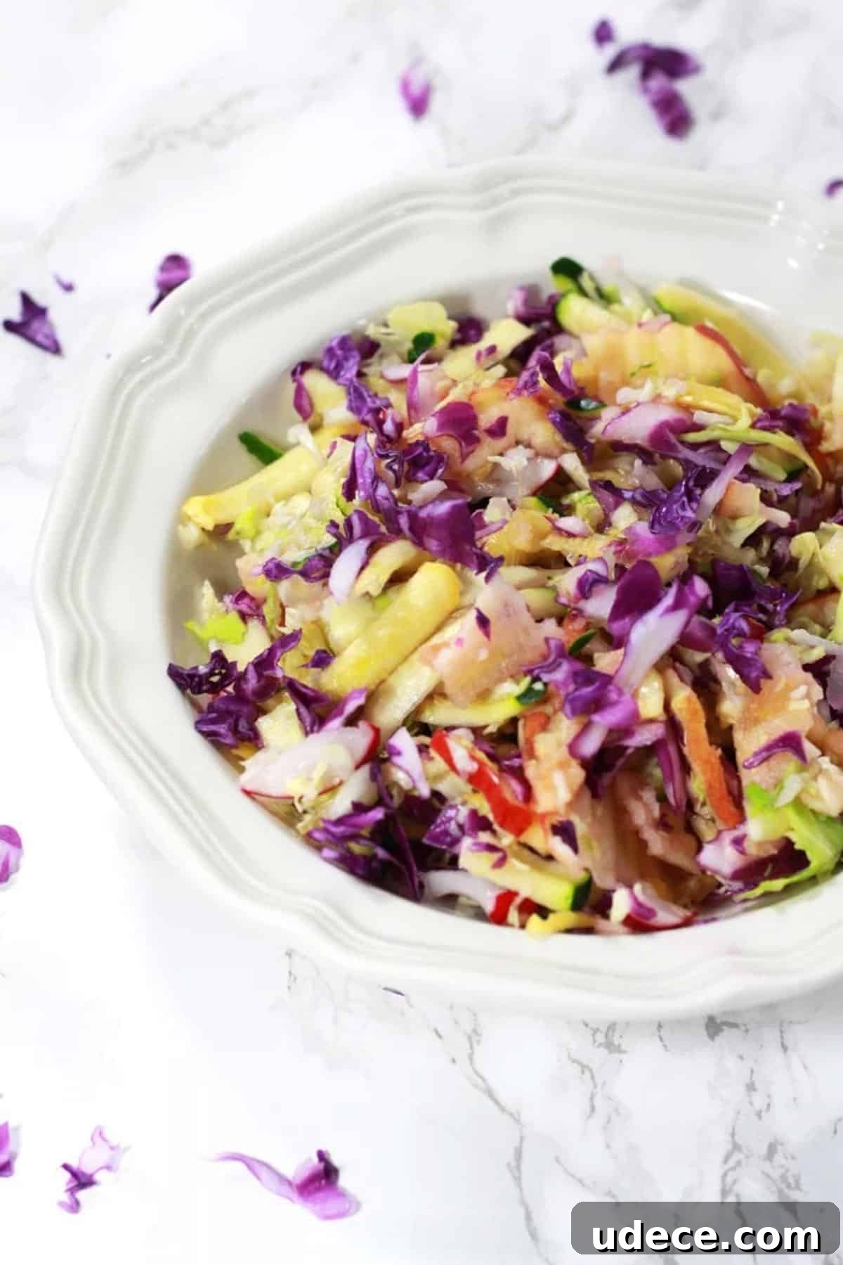 Sweet coleslaw with fruit and vegetables in a bowl.