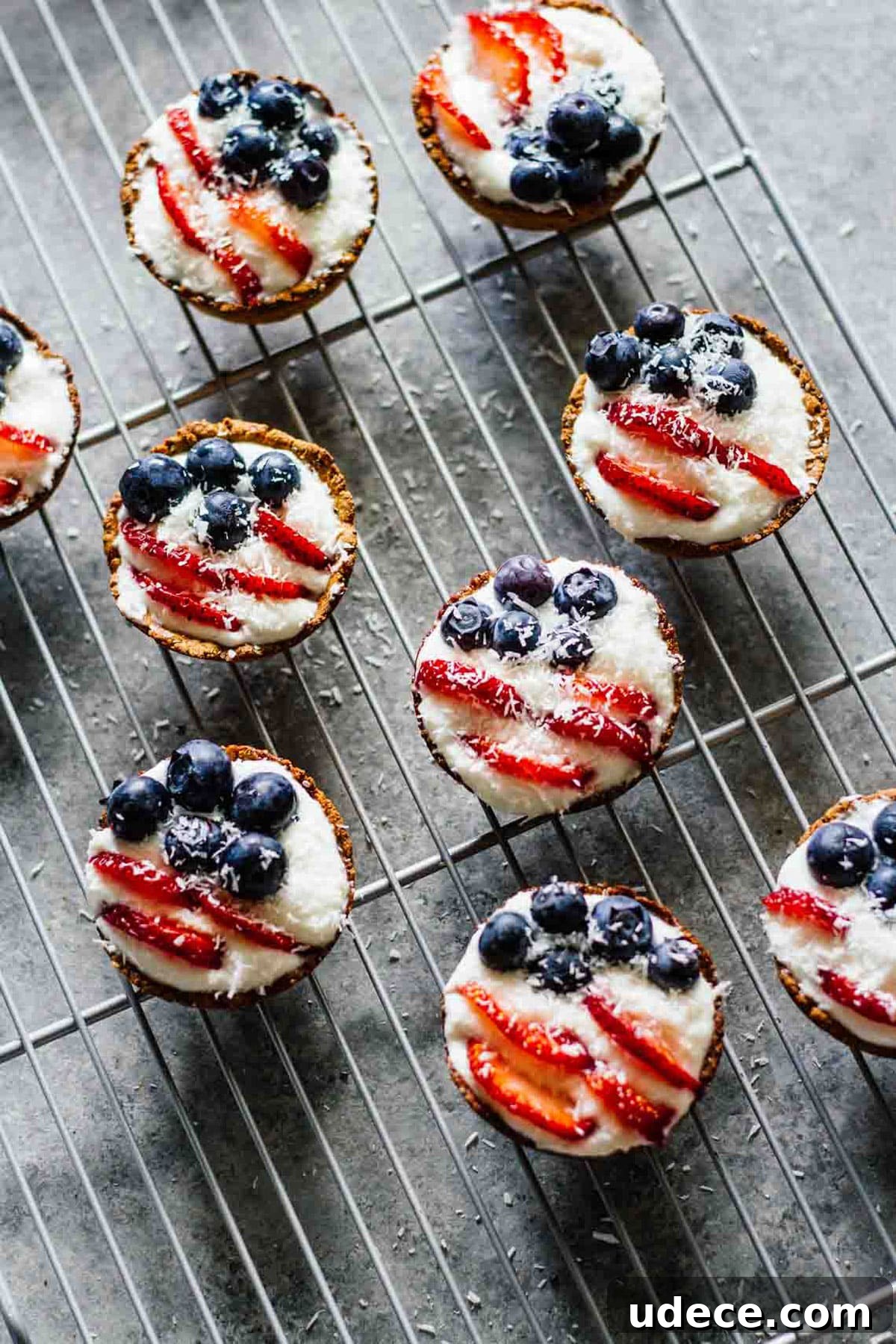 Mini patriotic tarts cooling on a wire rack.
