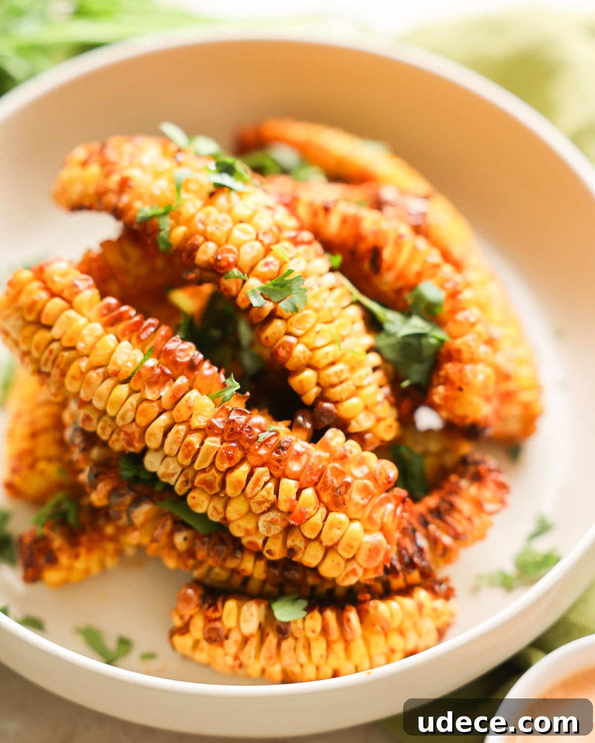 Crispy Corn Ribs Recipe: Tangy BBQ Flavor for Summer Cookouts 9 garnished corn ribs on plate