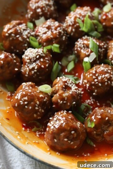 Sweet chili sauce in skillet with sesame seed and green onion.