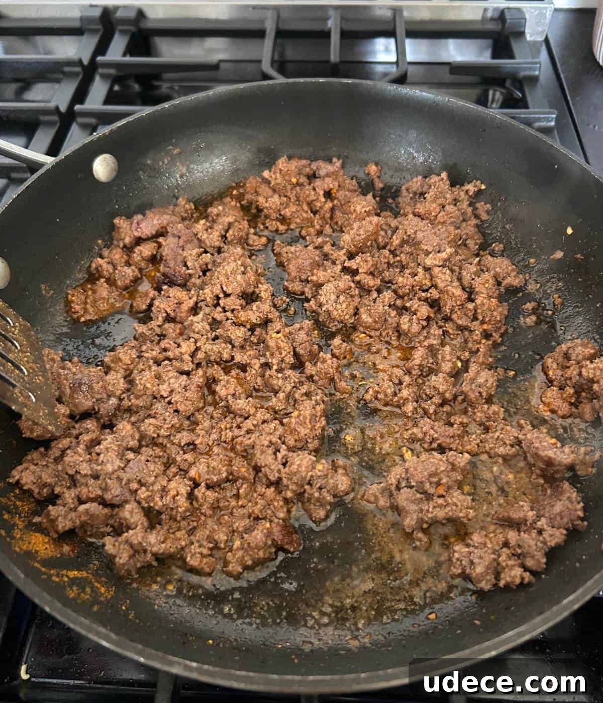 Crispy Ground Beef Tacos Recipe — Quick Weeknight Dinner 5 Seasoned ground beef in pan.