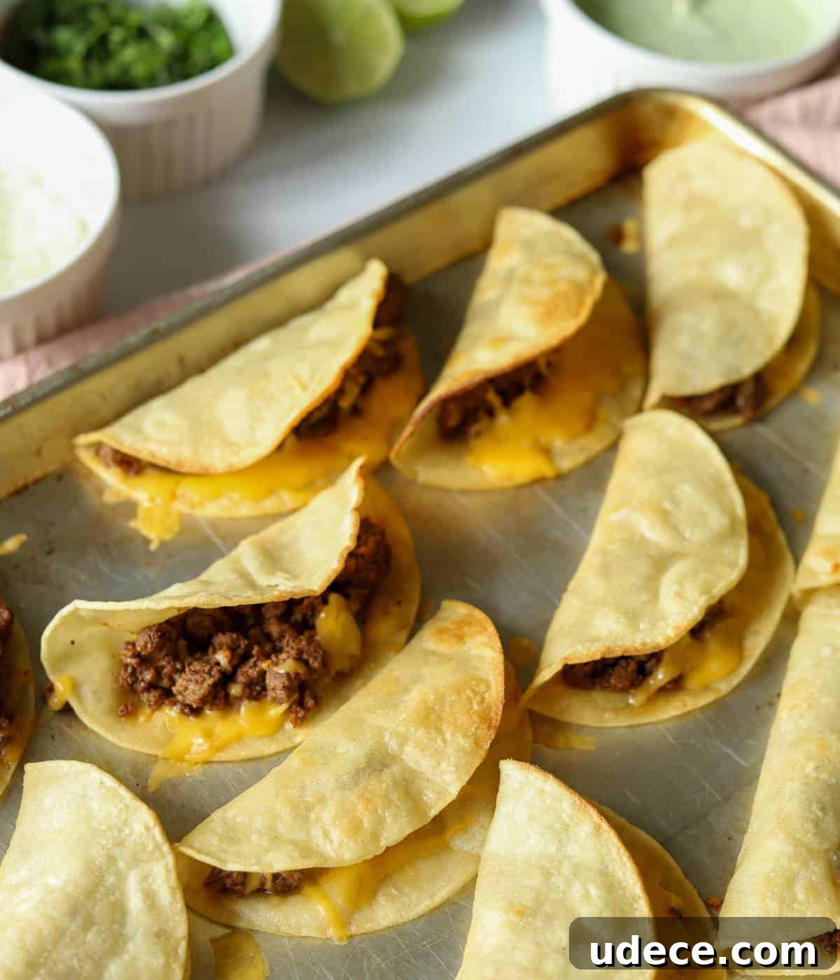 Crispy Ground Beef Tacos Recipe — Quick Weeknight Dinner 8 Crispy Beef Tacos on sheet pan.