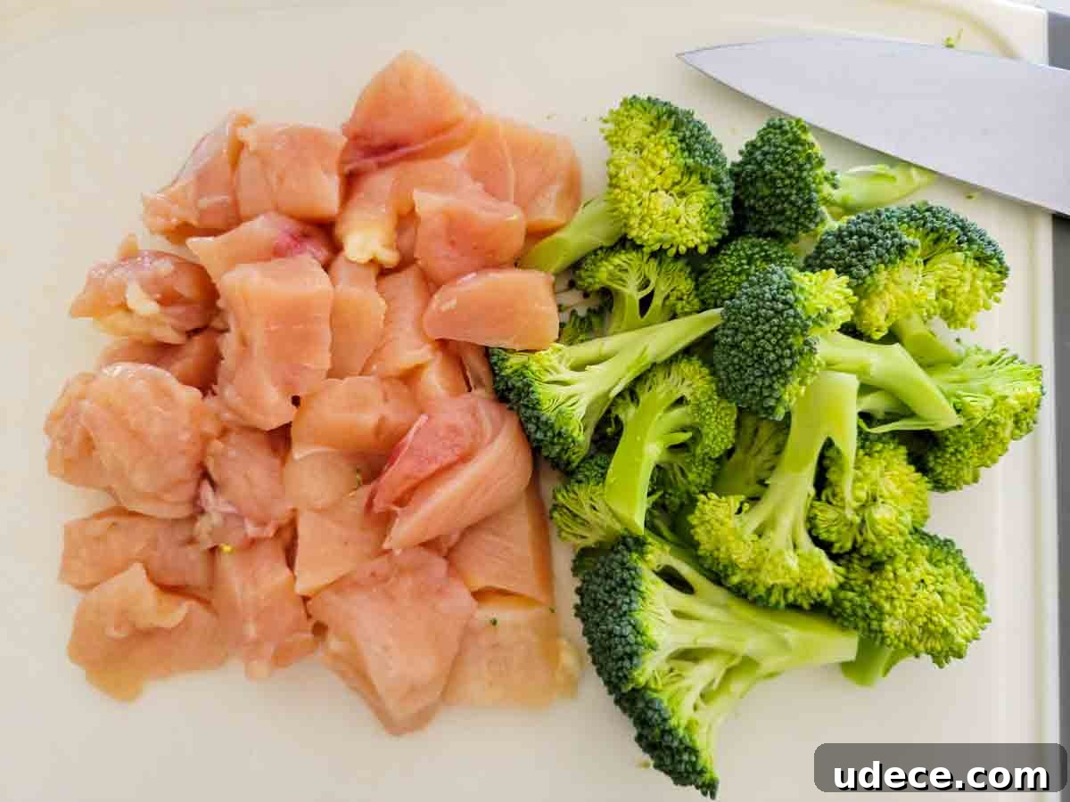 Slow-Cooker Chicken Poppy Seed Casserole Recipe 3 diced chicken and broccoli on a cutting board.