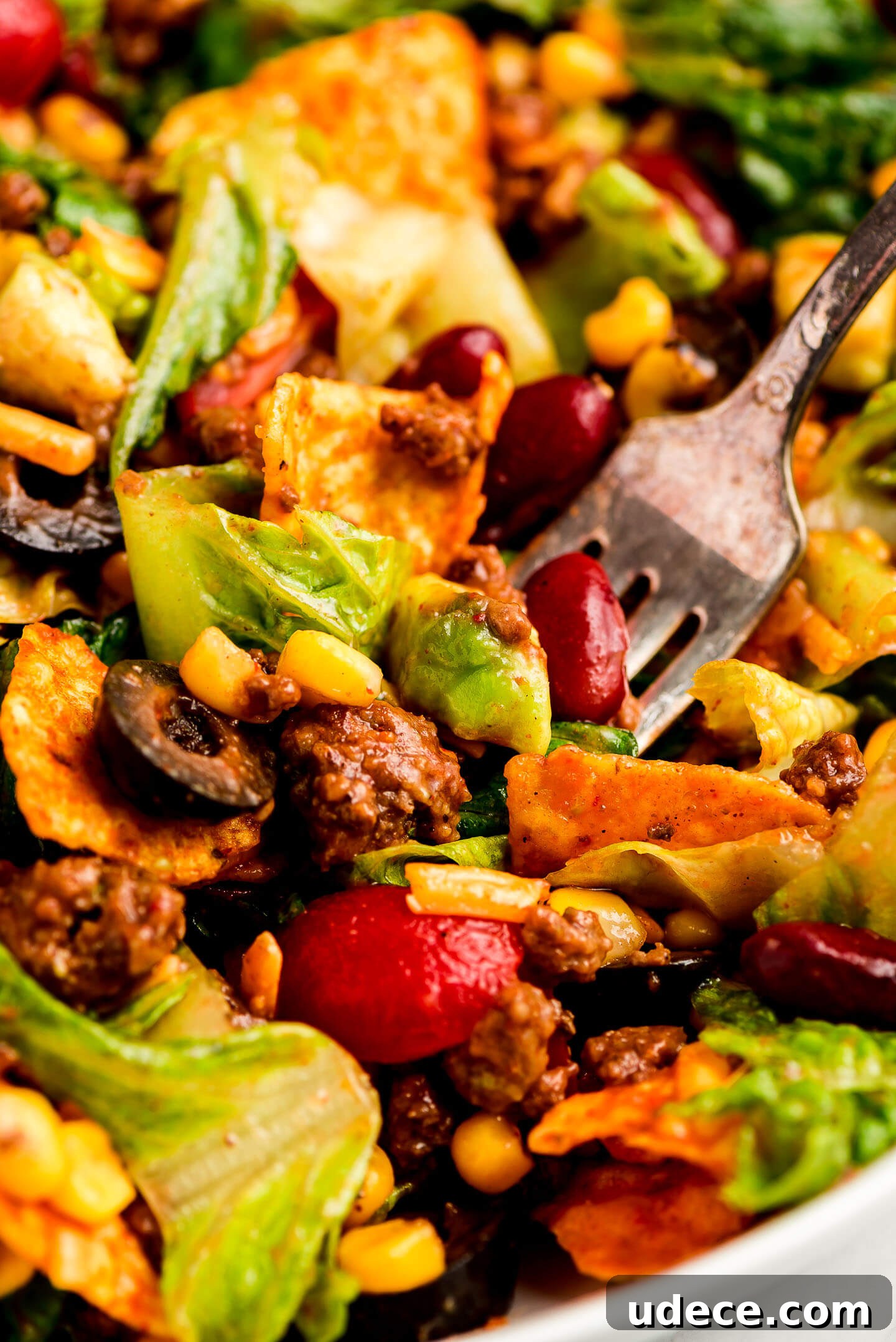 Close up shot of a fork full of Taco Salad.