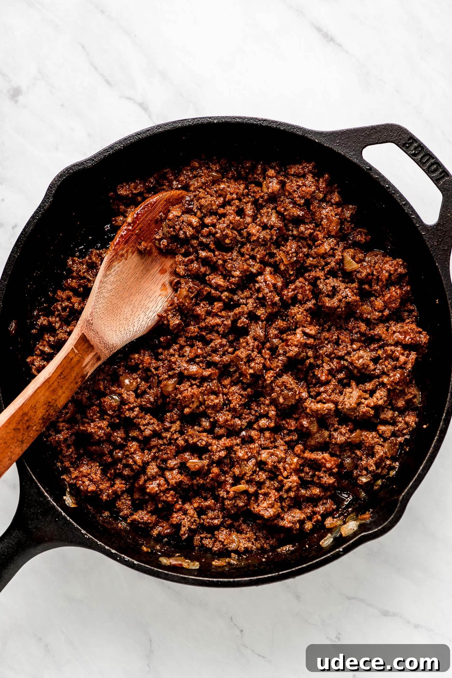 Ground taco meat in a cast iron skillet.