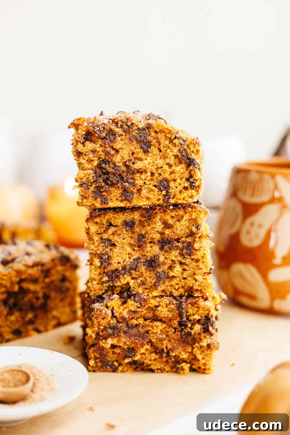 A stack of three slices of pumpkin chocolate chip cake.