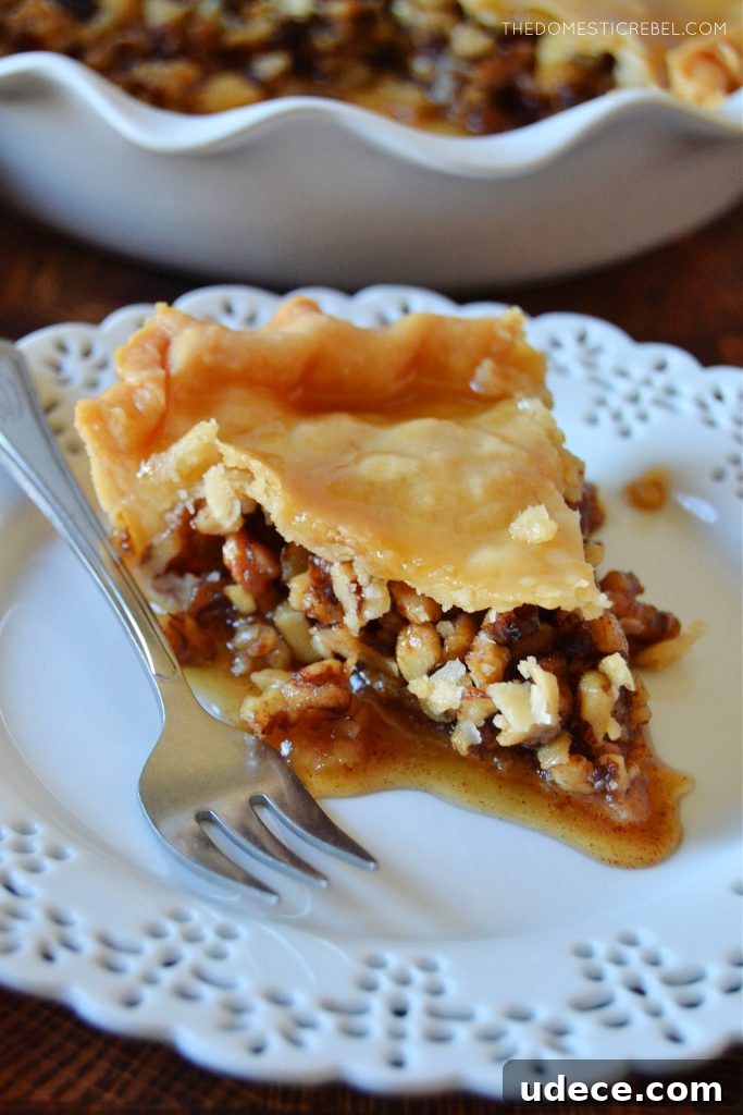 Crispy Baklava Pie Recipe with Honey-Walnut Filling 3 baklava pie slice on a white lace plate with a silver fork