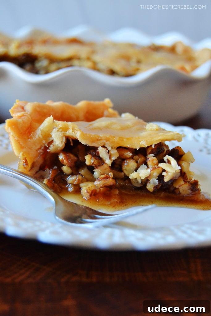 Crispy Baklava Pie Recipe with Honey-Walnut Filling 4 side profile of a slice of baklava pie on a white plate