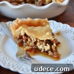 Crispy Baklava Pie Recipe with Honey-Walnut Filling 6 a piece of baklava pie on a white dessert plate with a silver fork