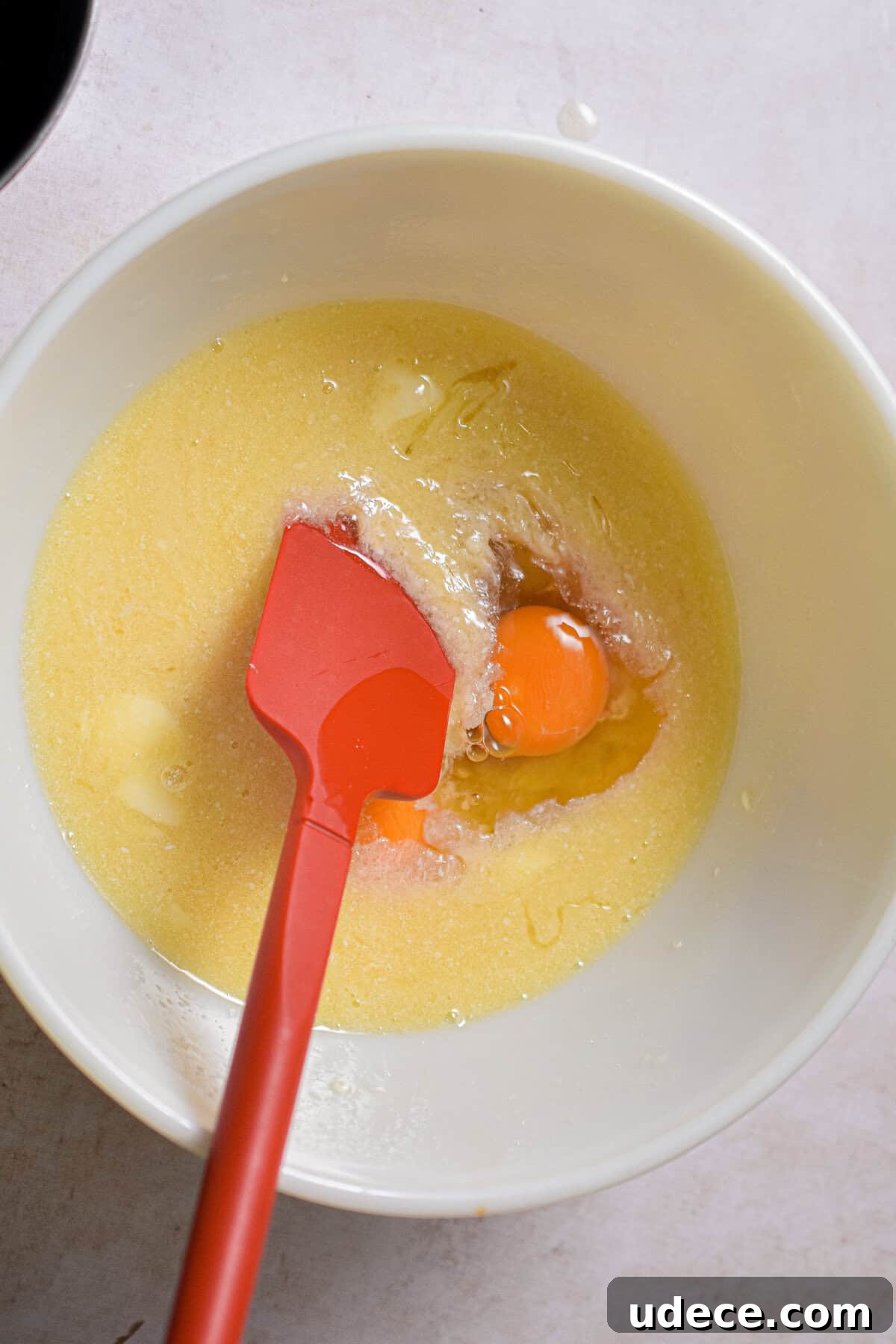 The eggs are added to the large mixing bowl.
