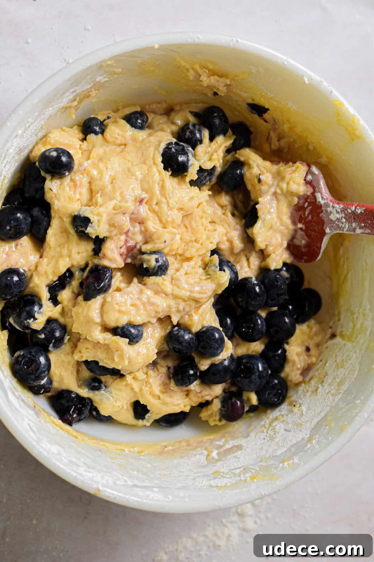 The blueberries are added to the batter.