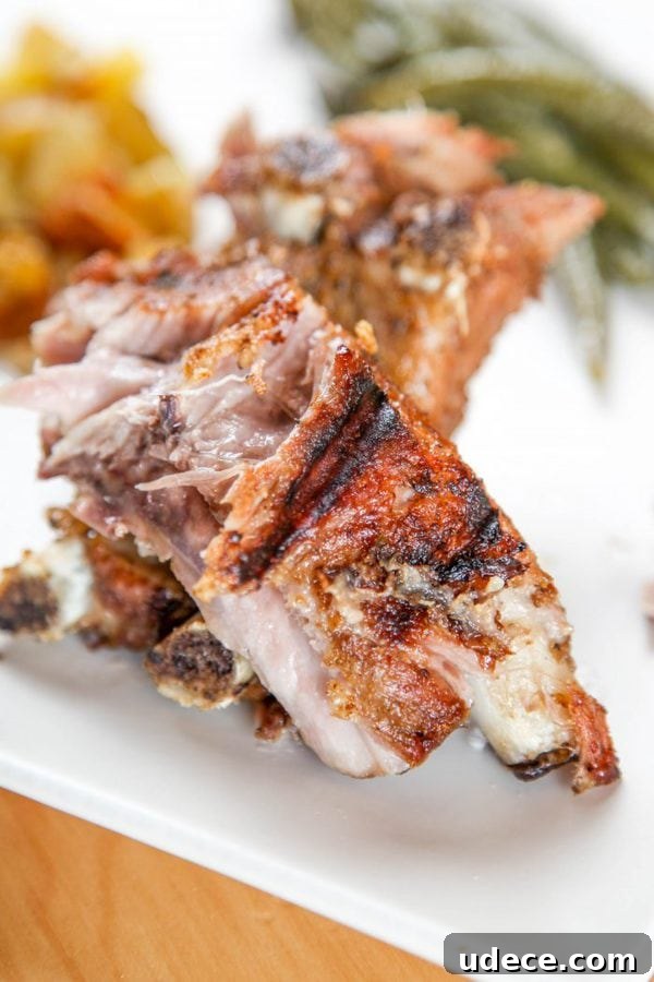 Juicy Instant Pot Ribs: Tender Stovetop-Style BBQ in 45 Minutes 6 instant pot ribs with potatoes and green beans in the background.