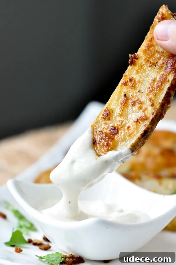 a roasted ranch potato being dipping into ranch dressing