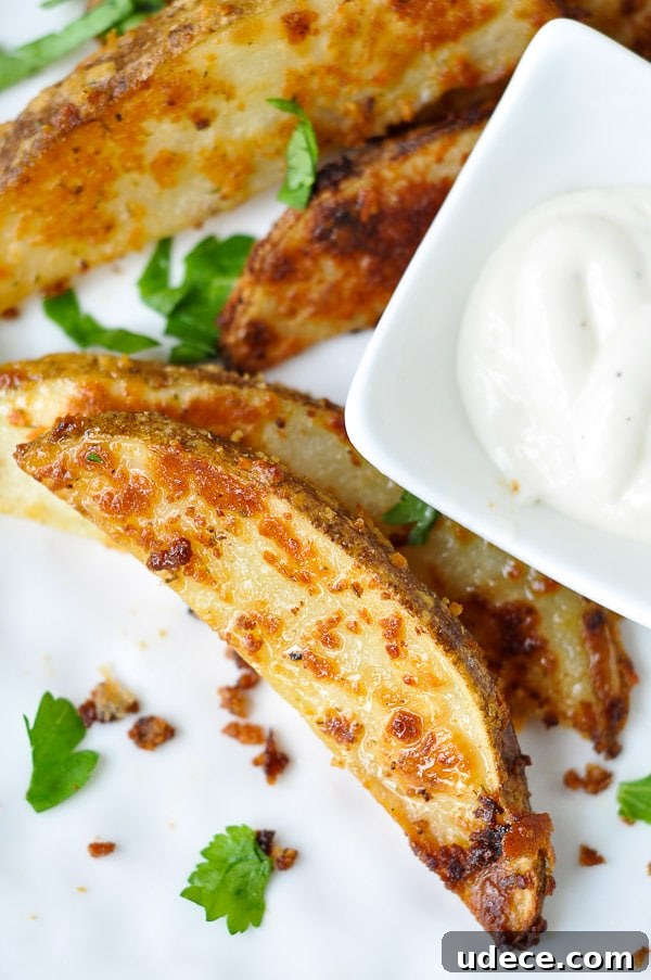 ranch potatoes on a white plate with a small bowl of ranch dressing next to it