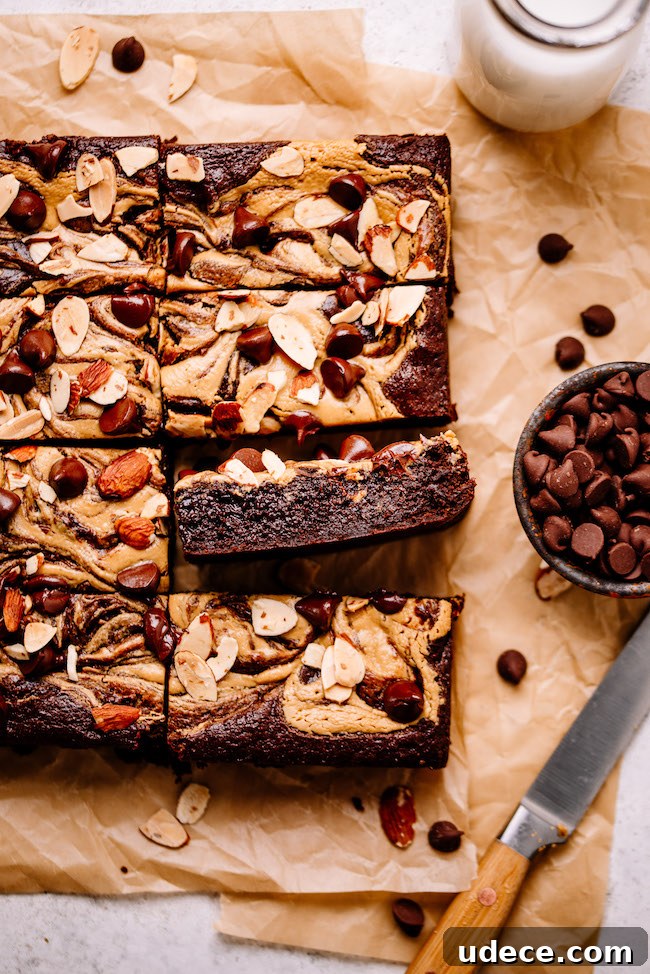 Almond Butter and Tahini Brownies Recipe for Moist Fudgy Bars 4 almond butter swirled brownies on parchment paper