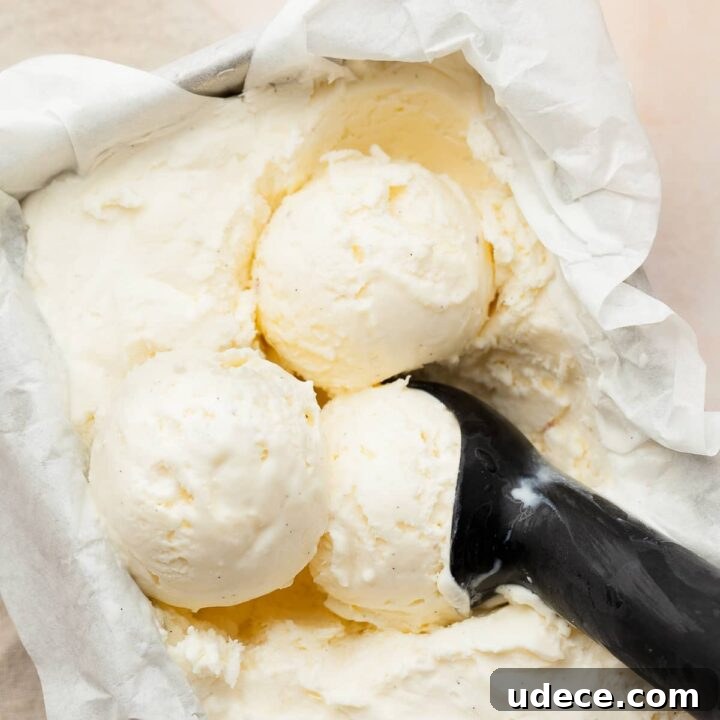 no churn vanilla ice cream in a loaf pan with an ice cream scooper