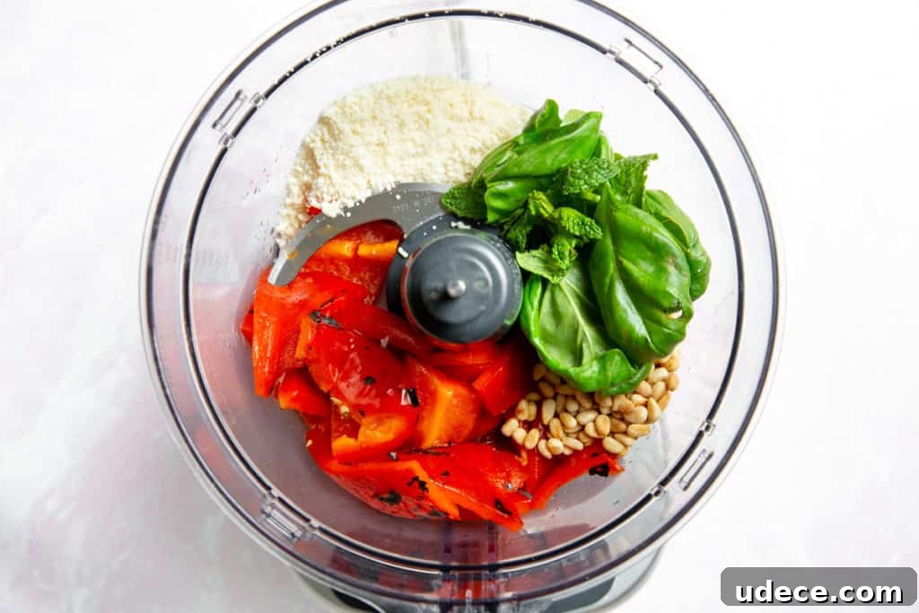 Roasted Red Pepper Pesto Pasta — Gluten-Free Recipe 8 Process shot showing the red pepper pesto ingredients in a food processor.