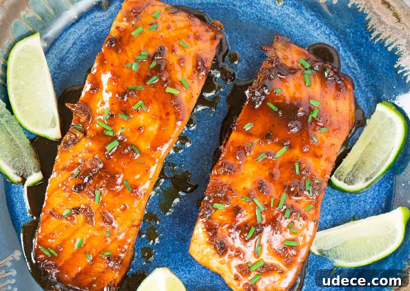 Sticky Honey-Glazed Salmon with Garlic and Soy 3 salmon fillets glazed with honey on a plate