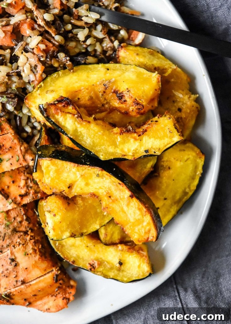 air fryer acorn squash on a plate with rice and chicken