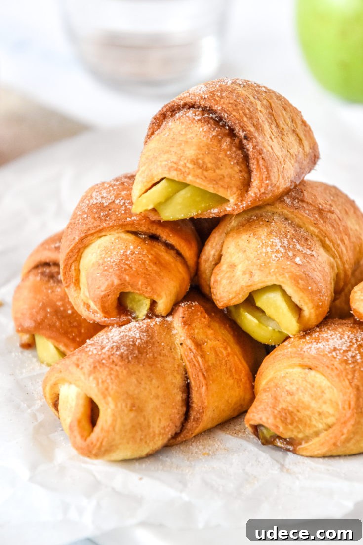 stack of air fryer apple pie crescent rolls with cinnamon sugar on top.