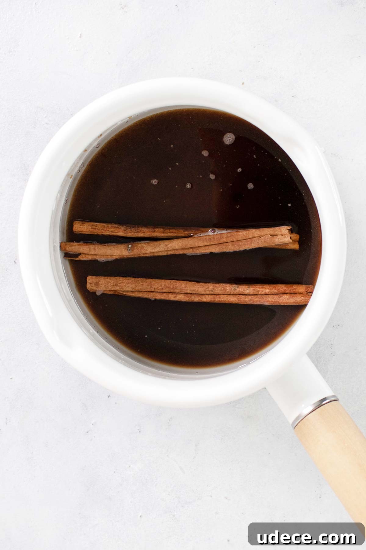 Brown Sugar Cinnamon Syrup Recipe — 3-Ingredient Homemade Syrup 5 Brown sugar cinnamon syrup in a white saucepan.