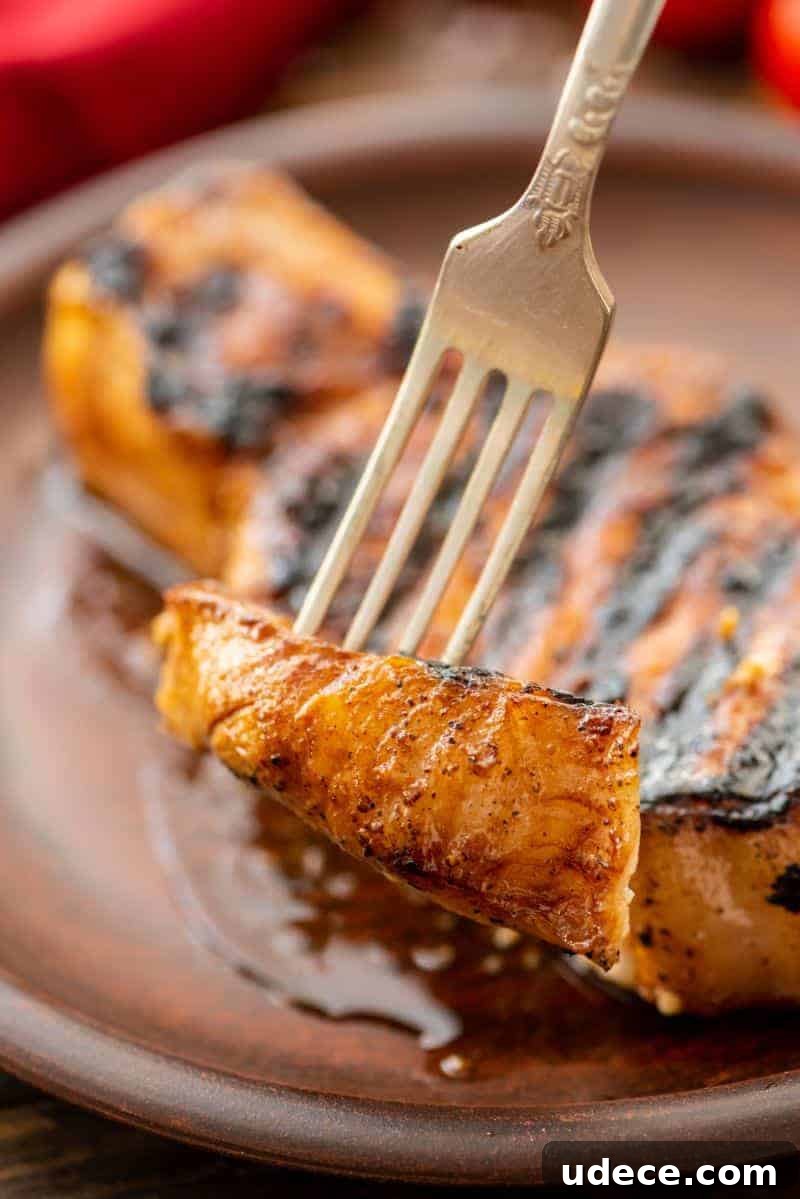 Savory Pork Chop Marinade for Juicy Grilled Chops 6 Piece of Grill-Pork-Chops on fork
