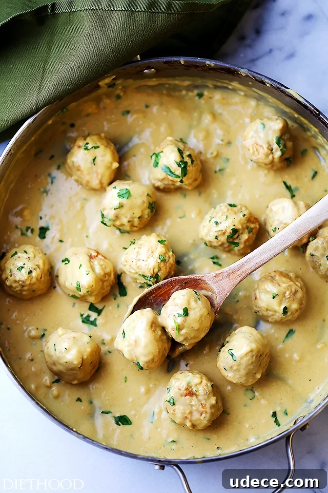 This baked turkey Swedish meatballs recipe with homemade mustard gravy is an easy twist on a classic comfort food. Turkey Swedish meatballs with homemade gravy in the pan.