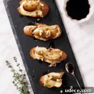 Crostini with brie and pear on board.