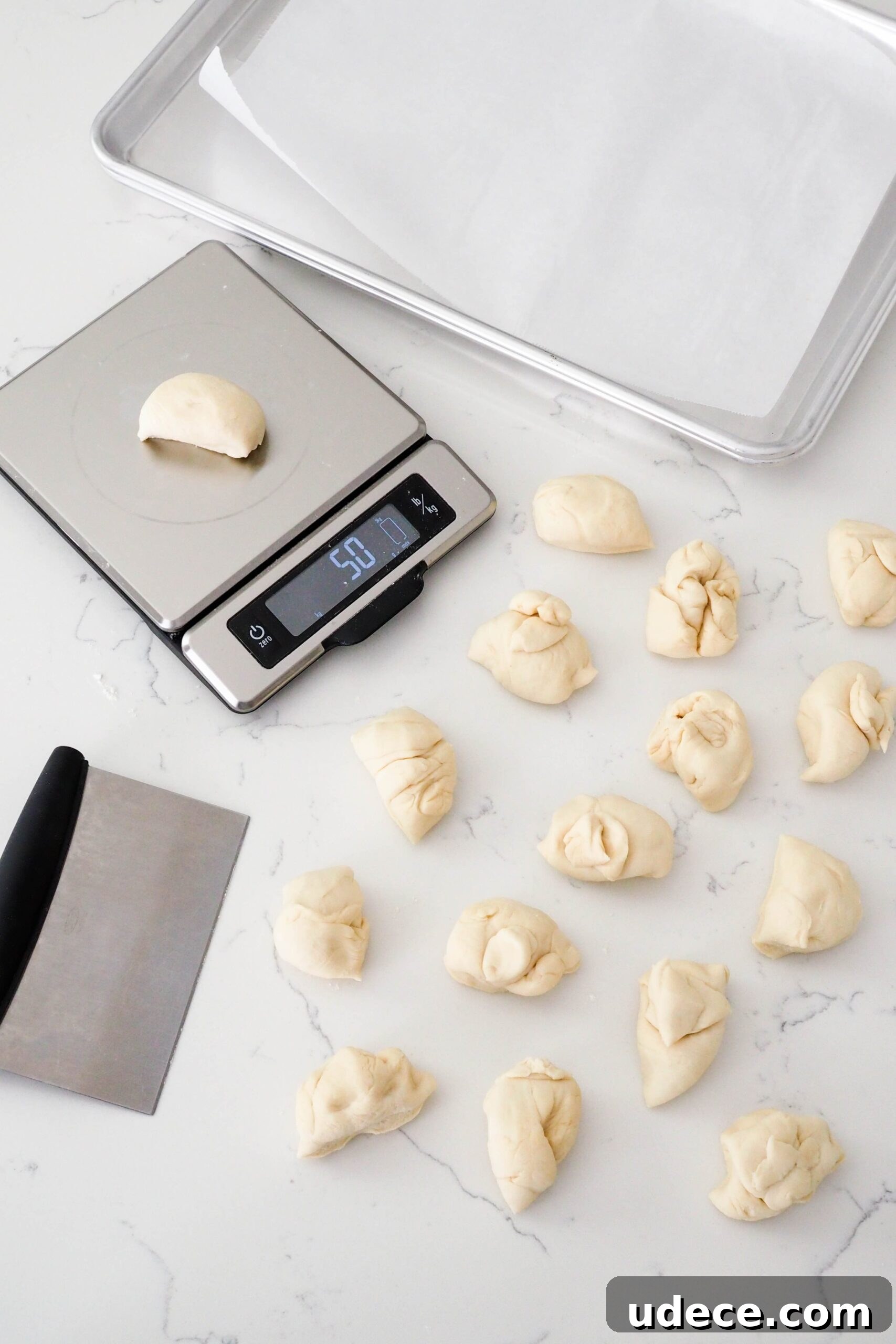 Crispy Homemade Garlic Breadsticks with Parmesan and Herbs 8 16 pieces of enriched dough are divided on a counter.