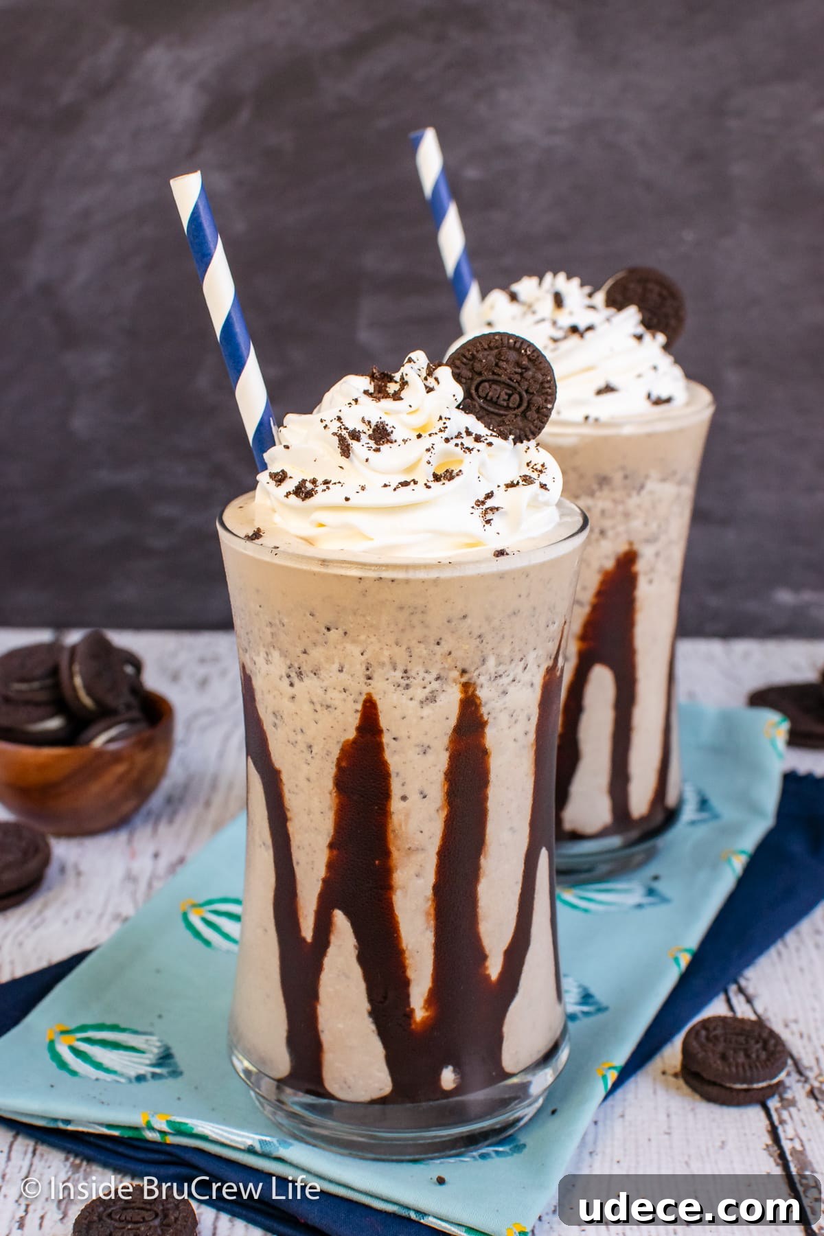 Creamy Oreo Milkshake Recipe: How to Make a Classic Cookies & Cream Shake 2 A cookie shake in a clear cup with chocolate drizzles.