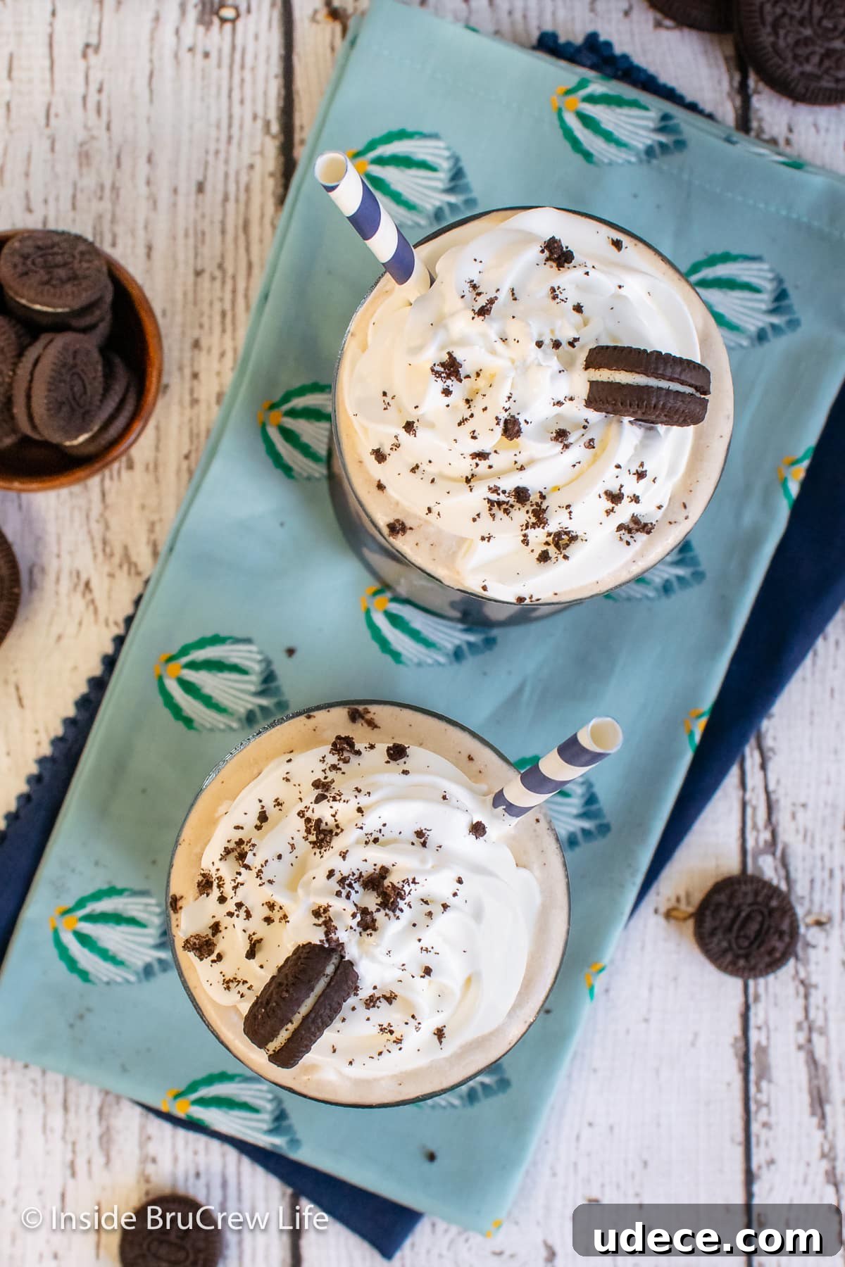 Creamy Oreo Milkshake Recipe: How to Make a Classic Cookies & Cream Shake 3 Overhead picture of two milkshakes topped with Cool Whip and Oreos.