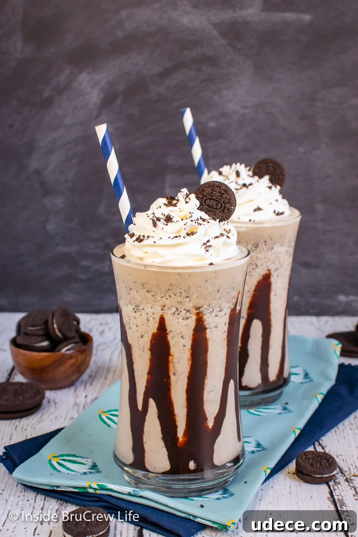 Creamy Oreo Milkshake Recipe: How to Make a Classic Cookies & Cream Shake 4 Two clear cups drizzled with chocolate and filled with a cookie shake.