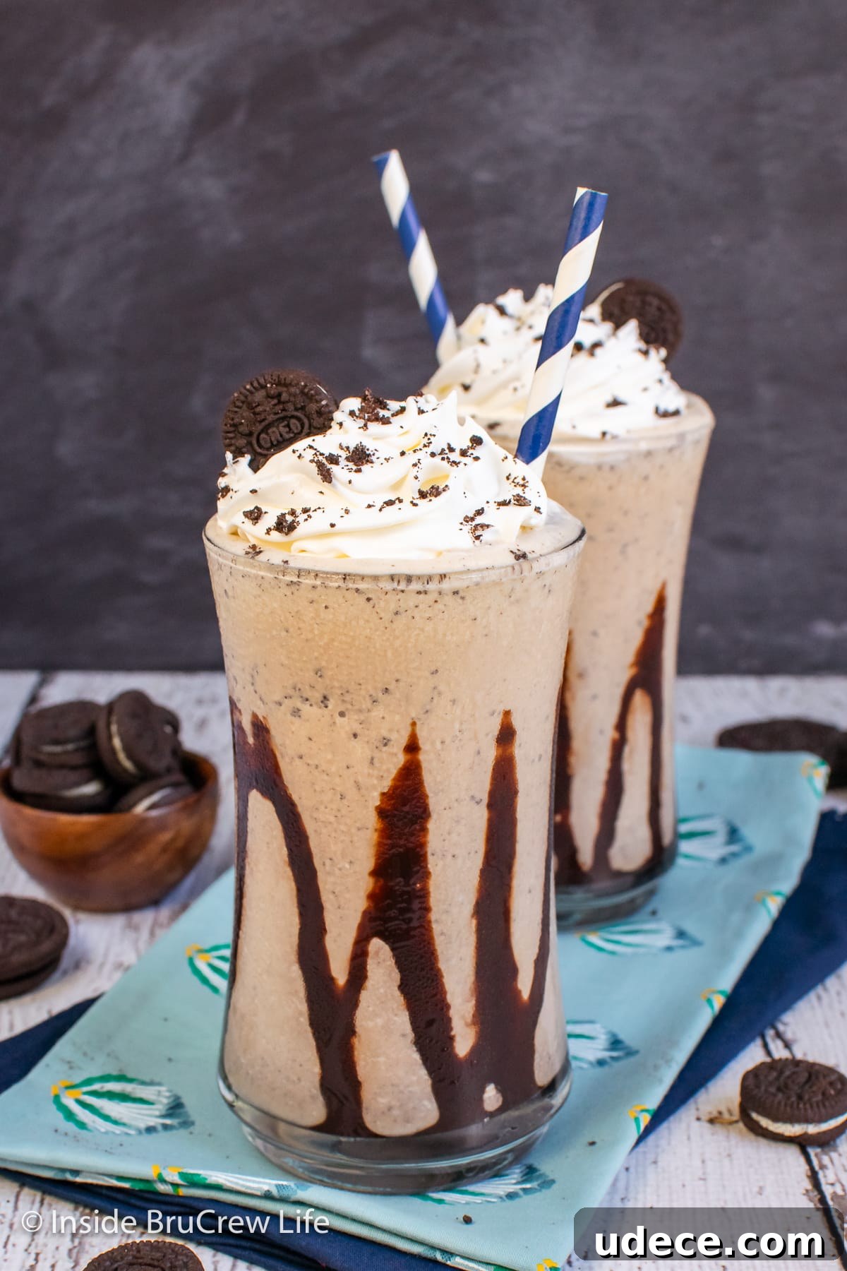 Creamy Oreo Milkshake Recipe: How to Make a Classic Cookies & Cream Shake 5 Two cups filled with an Oreo shake and drizzled with chocolate syrup.