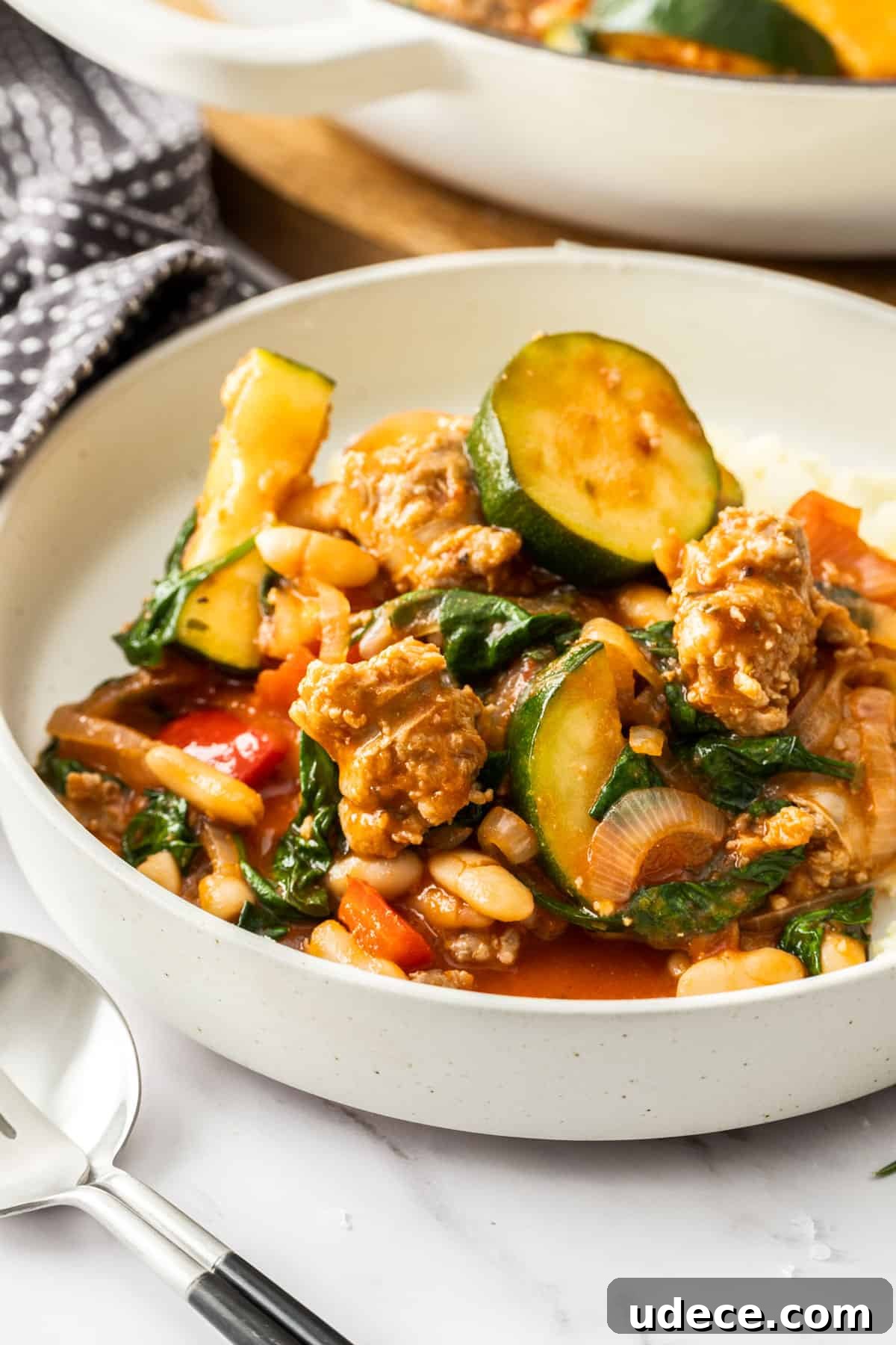 Mediterranean Sausage and Vegetable Casserole Recipe 7 Serving of Sausage Casserole in a small round white bowl.