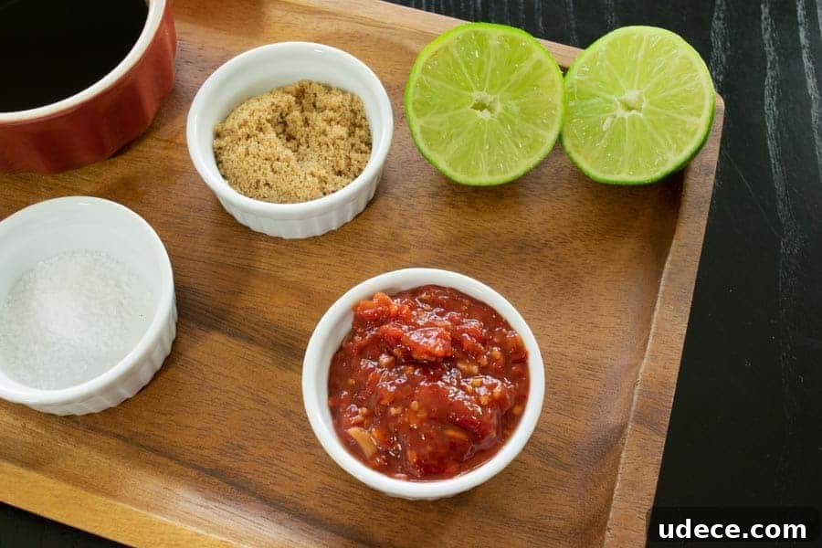 Chili lime jerky ingredients, lime, chili garlic, brown sugar on cutting board