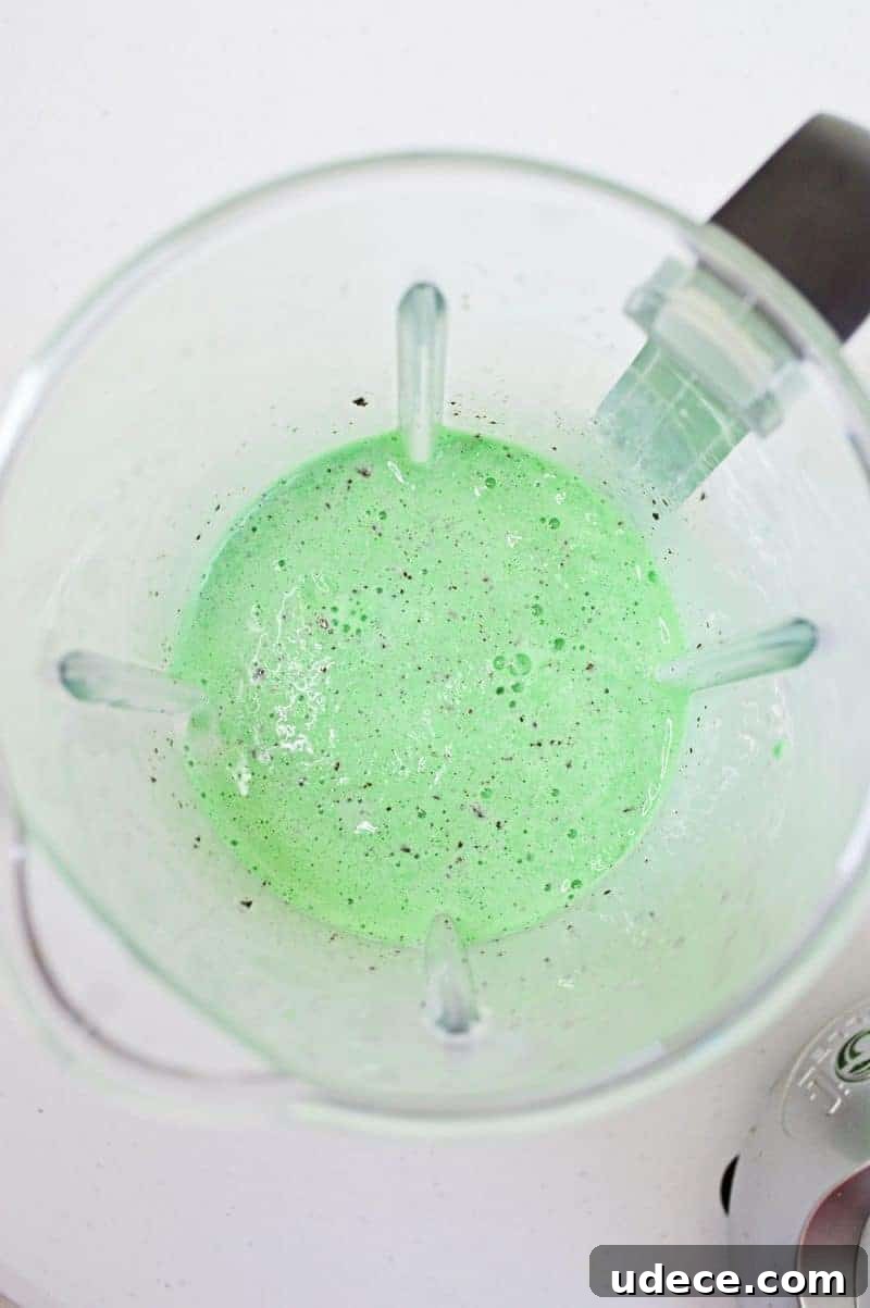 Shamrock Shake Recipe: Refreshing Minty Milkshake for St. Patrick’s Day 6 Bright green mint chocolate chip milkshake blended in blender