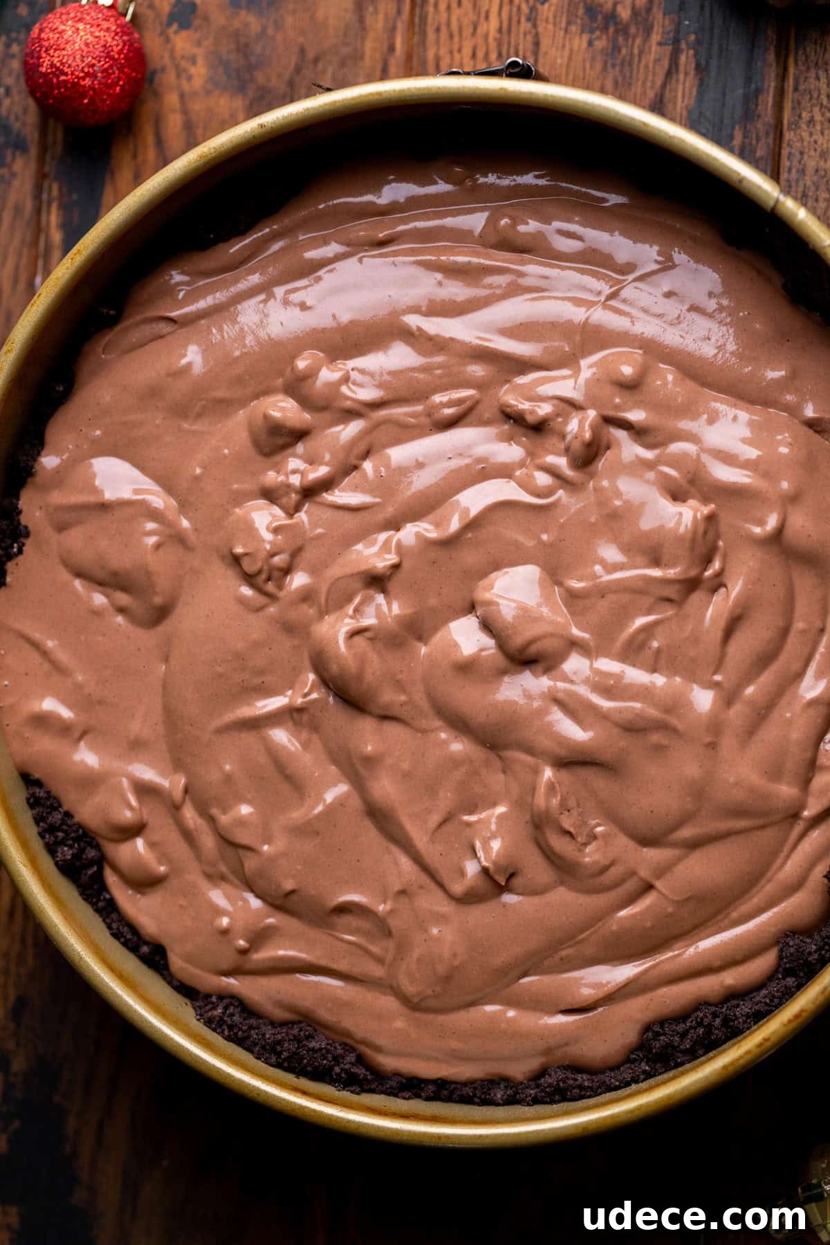 Chocolate cheesecake batter in pan.