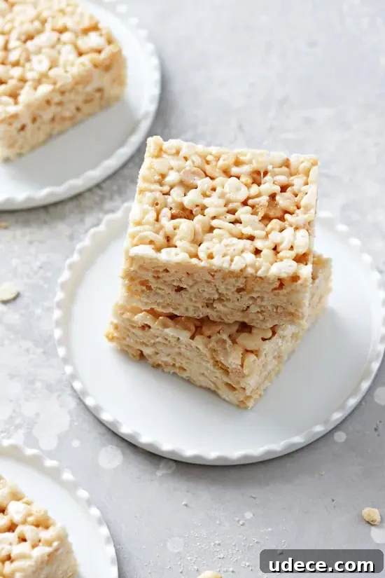 Dairy-Free Rice Krispies Treats: Crispy No-Milk Recipe 5 Dairy Free Rice Krispy Treats on small white plates.