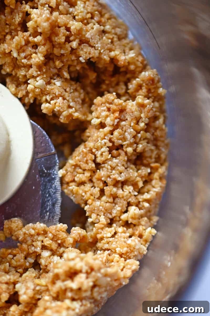 Vegan Coconut Cream Bars — Low-Carb, Gluten-Free Dessert 7 An open food processor with the crust ingredients for coconut cream bars.