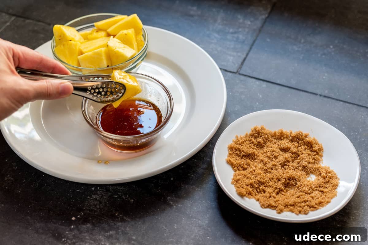 Crispy Bacon-Wrapped Pineapple Bites: Sweet and Savory Appetizer 4 dipping pineapple chunk in maple syrup.