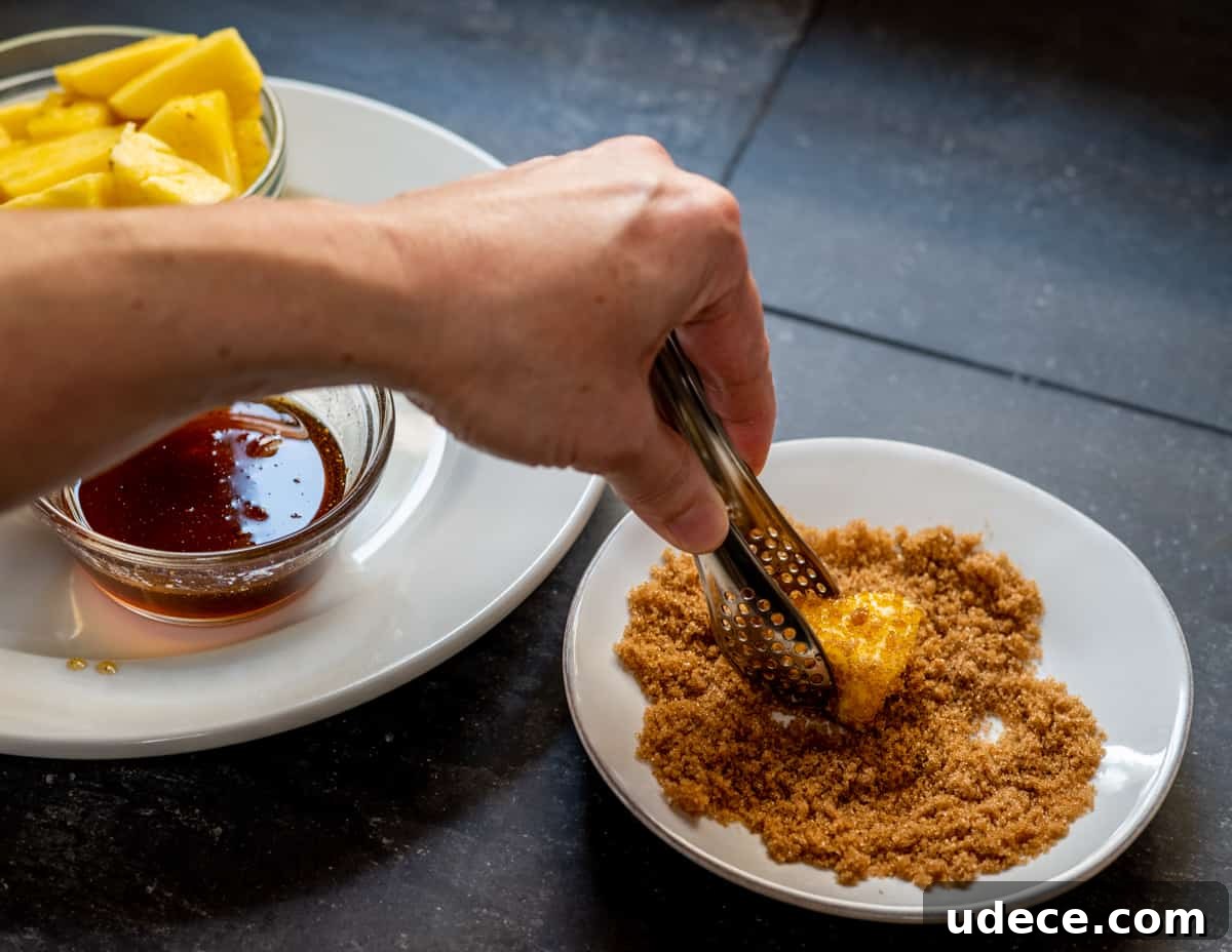 Crispy Bacon-Wrapped Pineapple Bites: Sweet and Savory Appetizer 5 coating pineapple chunk in brown sugar.