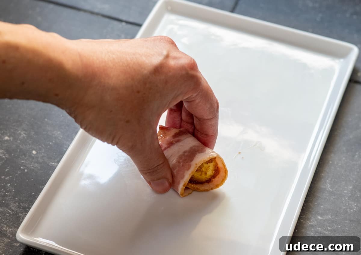 Crispy Bacon-Wrapped Pineapple Bites: Sweet and Savory Appetizer 7 coated pineapple wrapped in raw bacon.