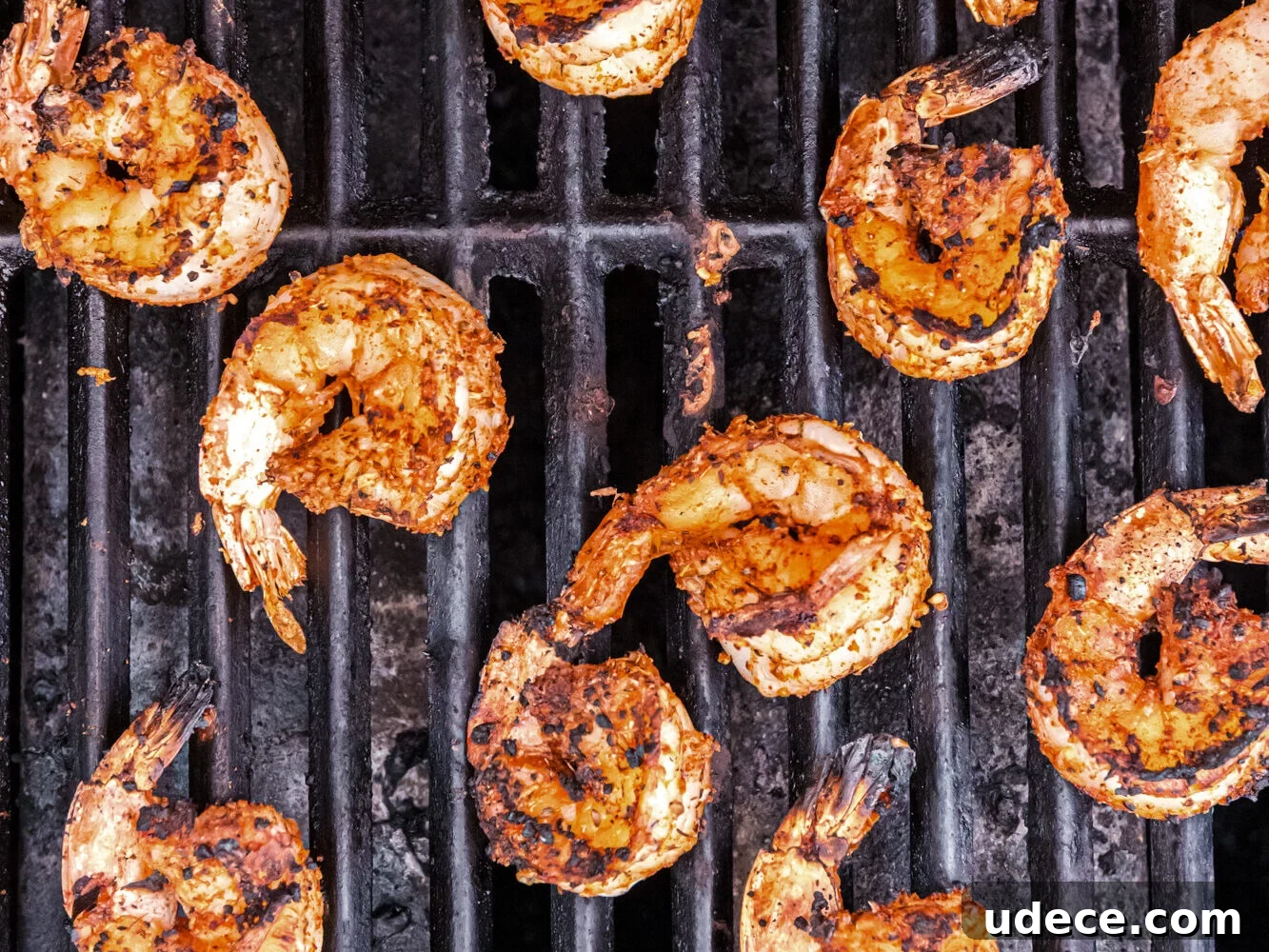 Spicy Cajun Grilled Shrimp Recipe for Quick Weeknight Meals 7 Shrimp developing charred grill marks as they cook, turning golden brown.