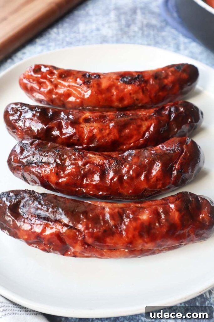 Crispy Air Fryer Chicken Sausage Recipe 4 white plate with four air fryer chicken sausages