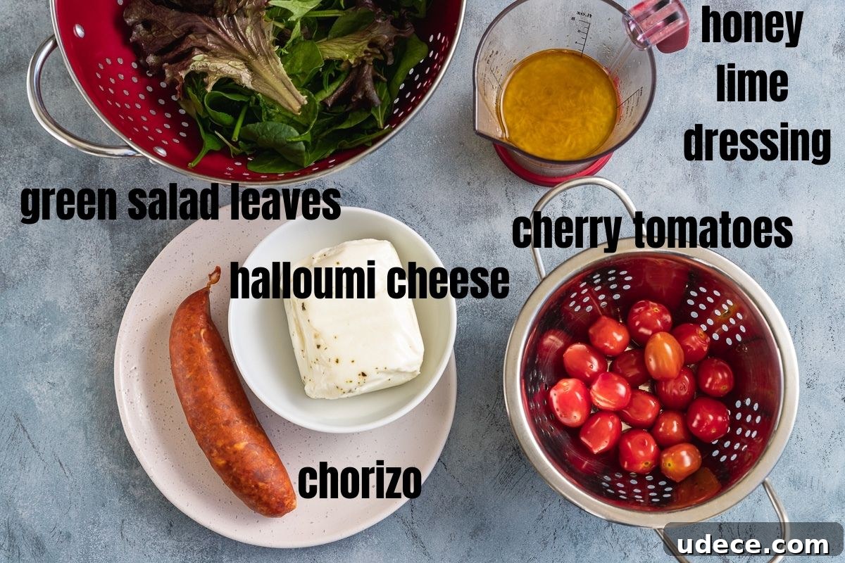 All the ingredients you need to make halloumi kebabs with chorizo and tomatoes including green salad leaves, honey lime dressing, halloumi cheese log, chorizo sausage and cherry tomatoes