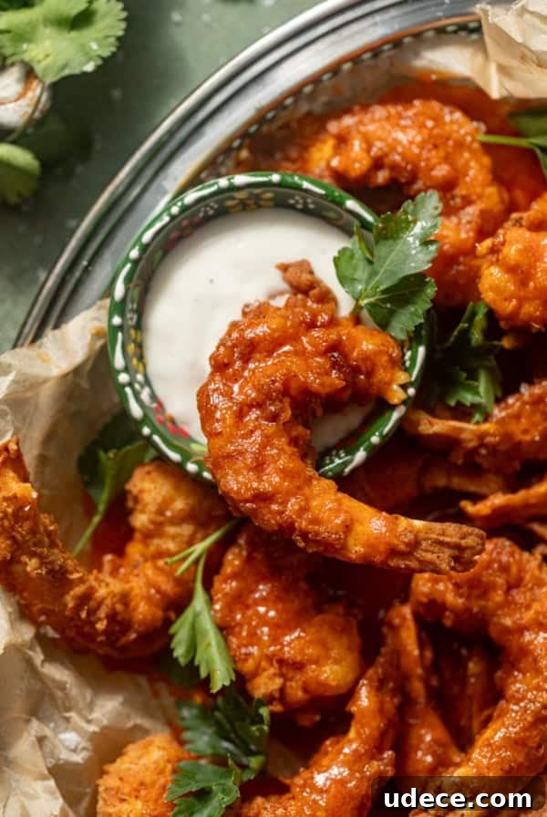 buffalo shrimp in a basket with a small bowl of blue cheese.