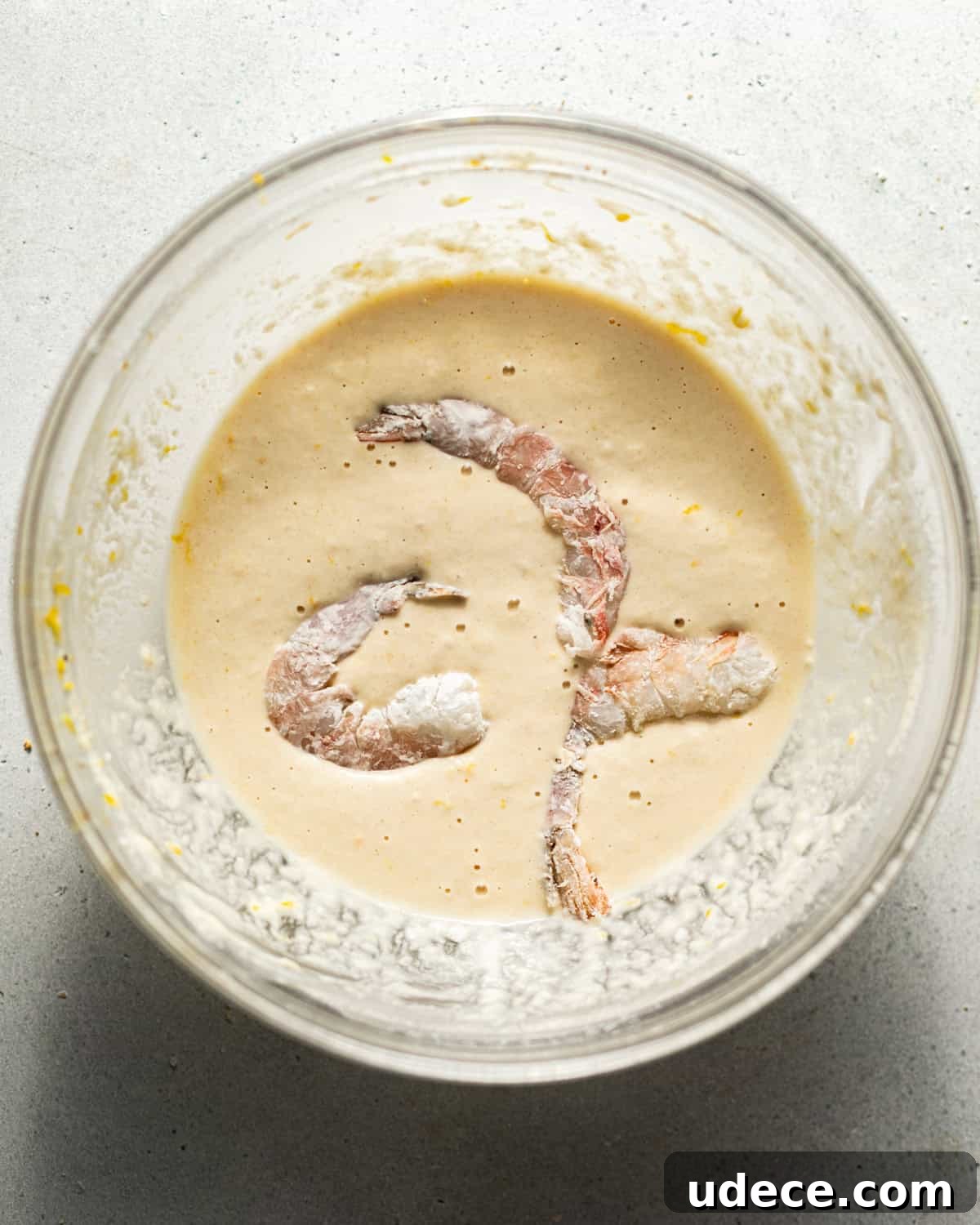 shrimp dipped in beer batter before frying.